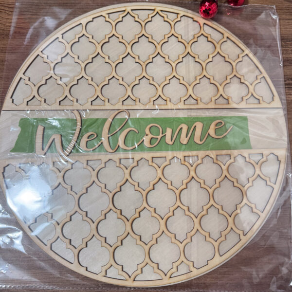 unfinished wooden round welcome sign kit with repeating geometric pattern and layered welcome lettering ready for painting