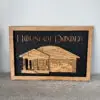 Wood-framed black chalkboard sign reading 'House of Doody' with a wooden house illustration plate beneath.