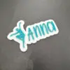 Teal acrylic name magnet reading Anna with a dancer silhouette on a white backing